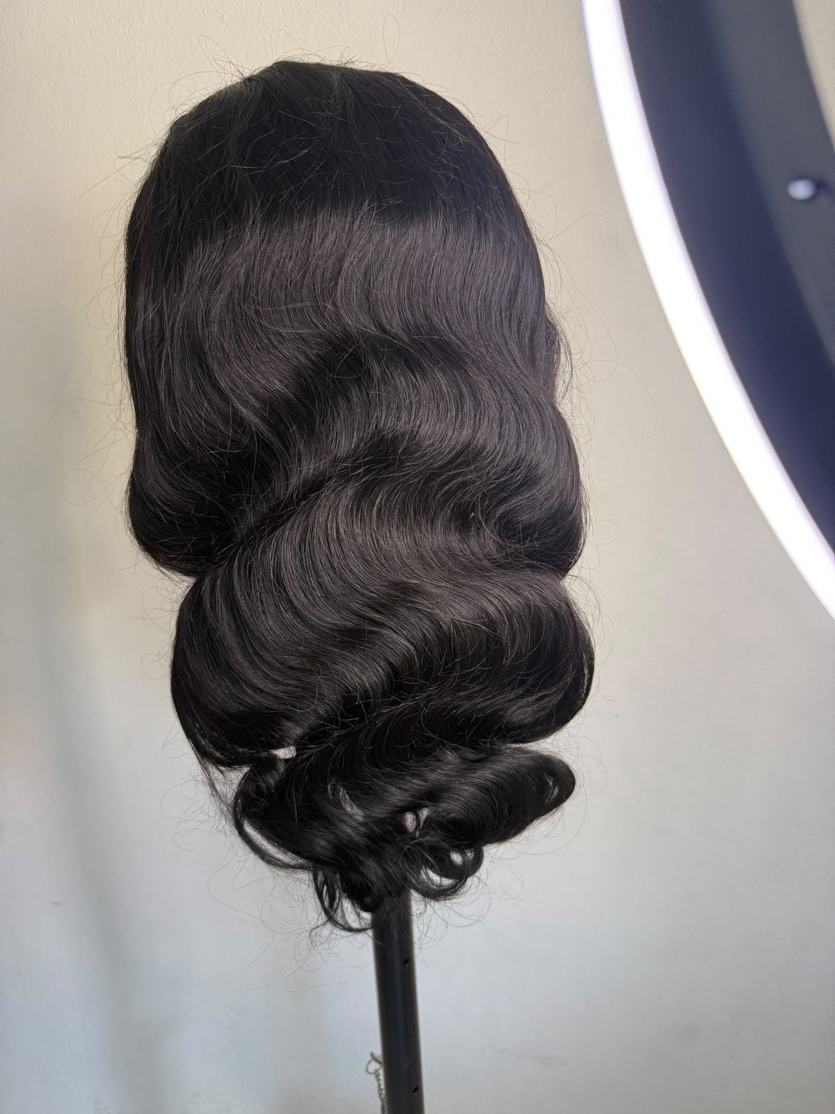 26 inch natural black body wave human hair wig, back view on a wig stand